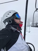 Skier with tongue out catching snowflakes